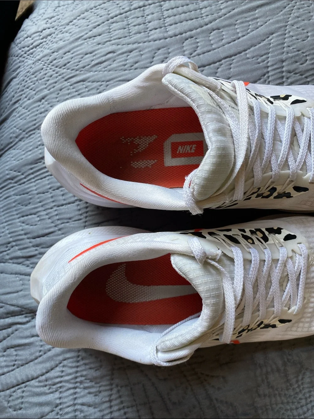Nike White Running Shoes with Orange Swoosh and Leopard Accents
